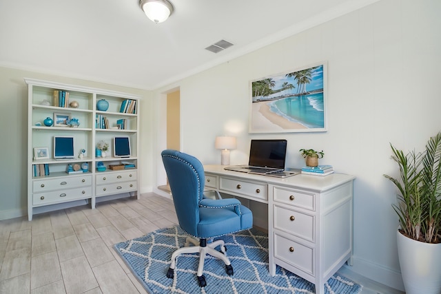 office area featuring ornamental molding, light hardwood / wood-style flooring, and built in desk