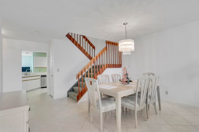 tiled dining room with sink and a notable chandelier