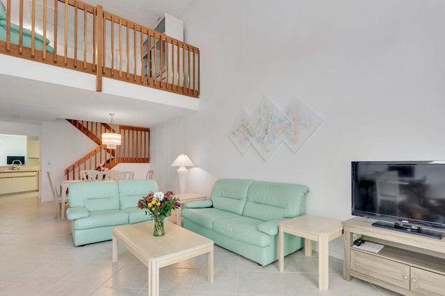 tiled living room with sink and a high ceiling