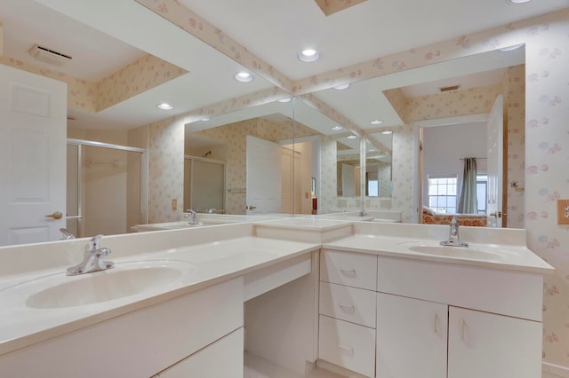 bathroom with vanity and a shower with shower door