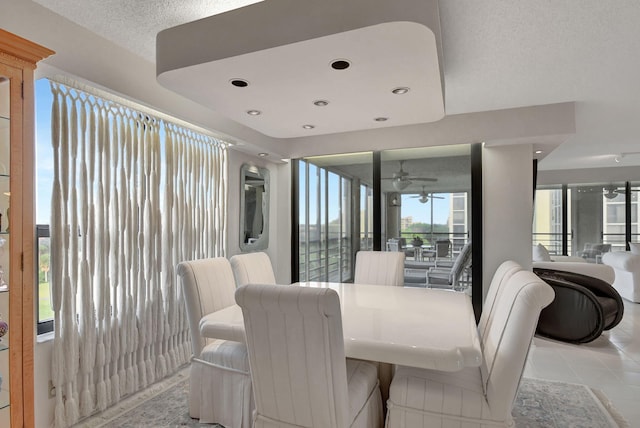 dining room with light tile patterned flooring, a textured ceiling, and ceiling fan