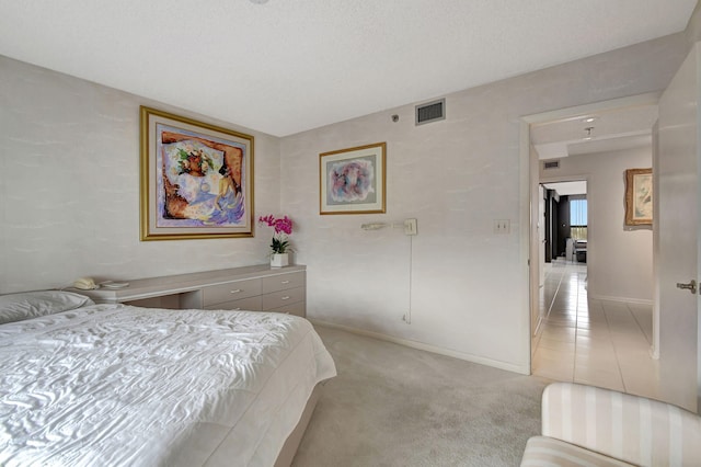 carpeted bedroom with a textured ceiling