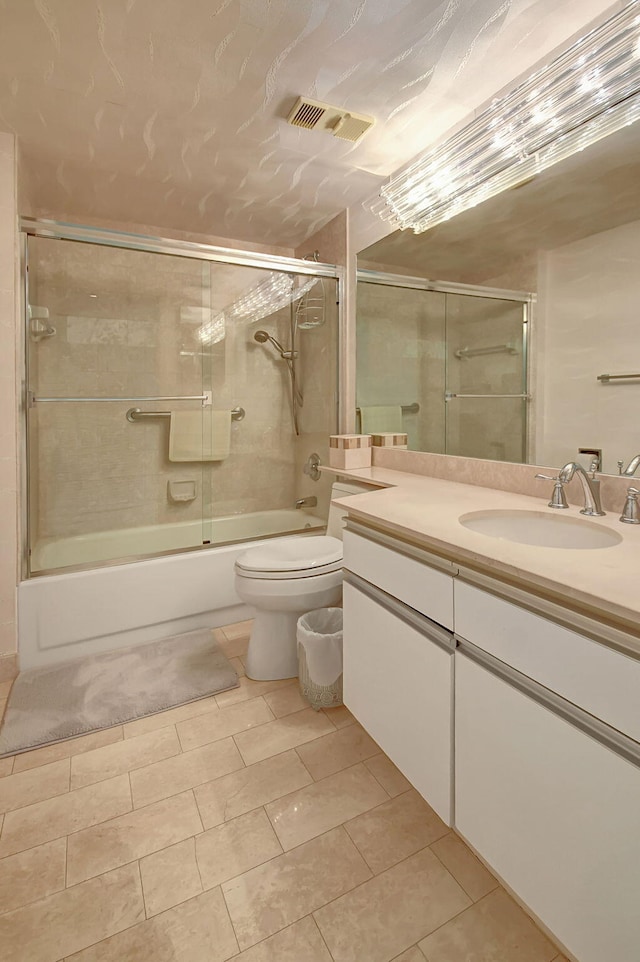 full bathroom featuring tile patterned floors, vanity, combined bath / shower with glass door, and toilet