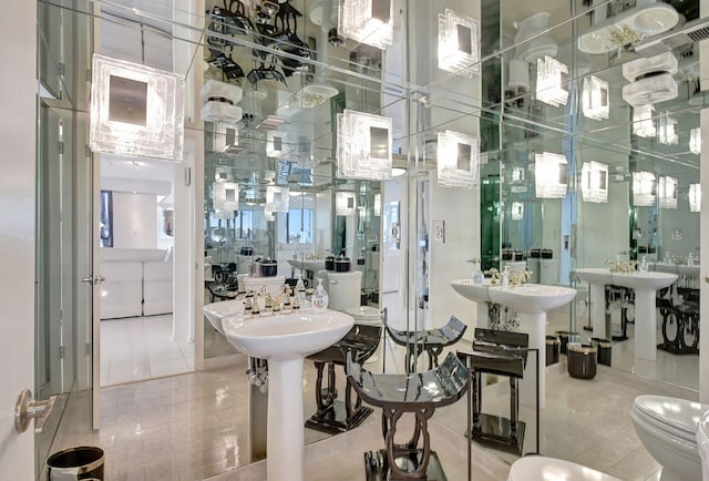 bathroom with dual sinks and tile patterned floors