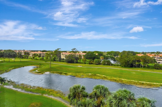 view of property's community featuring a lawn and a water view