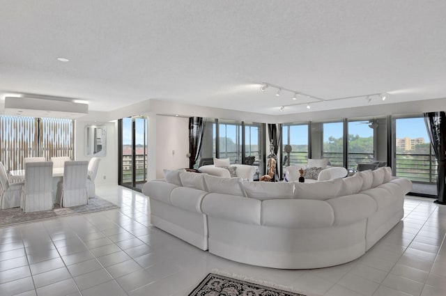 tiled living room with a textured ceiling and rail lighting