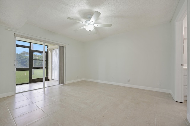 tiled spare room with ceiling fan and a textured ceiling