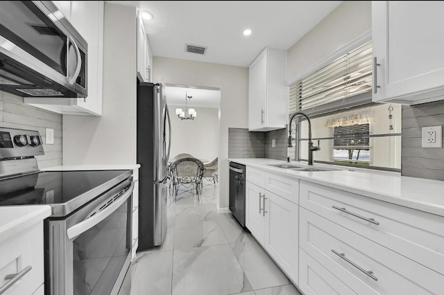 kitchen featuring visible vents, decorative backsplash, marble finish floor, a sink, and appliances with stainless steel finishes
