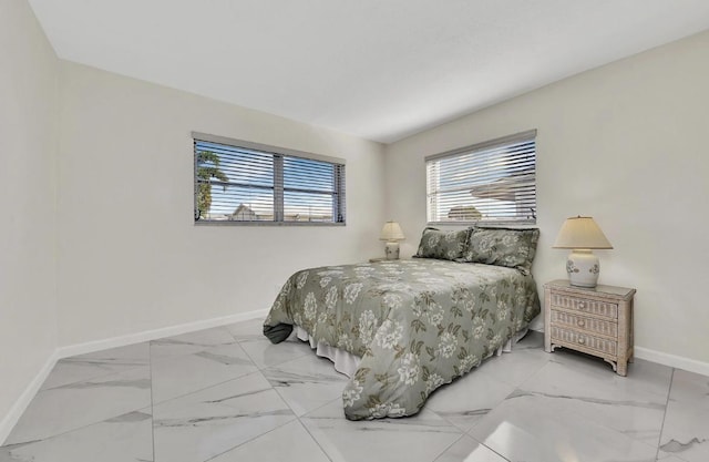 bedroom featuring baseboards and marble finish floor