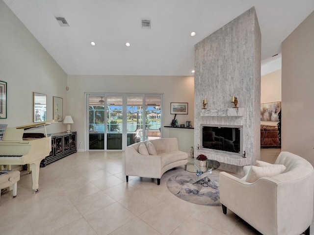 living room with light tile patterned flooring, a fireplace, and vaulted ceiling