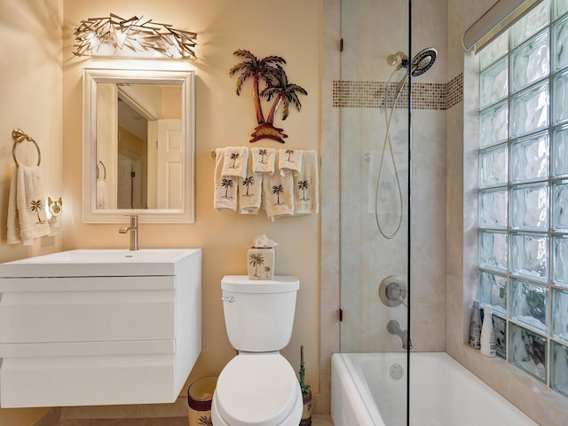 full bathroom featuring vanity, toilet, and tiled shower / bath