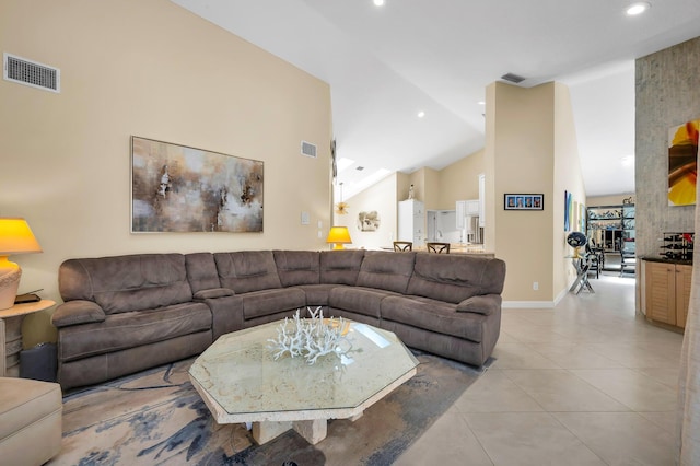 living room with vaulted ceiling and light tile patterned floors