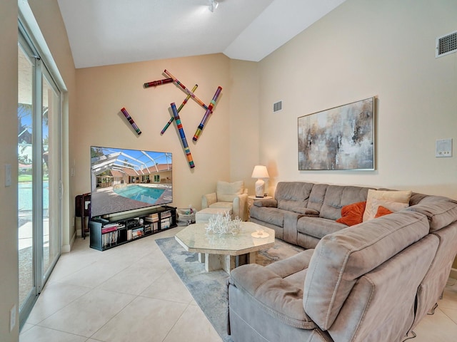 tiled living room featuring vaulted ceiling