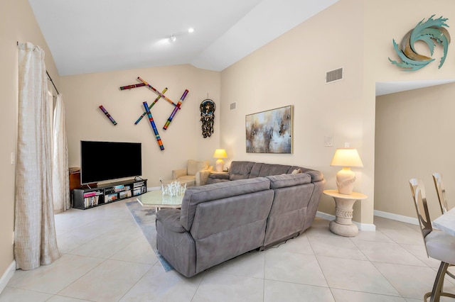 tiled living room featuring vaulted ceiling