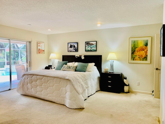 bedroom featuring a textured ceiling, access to exterior, and light colored carpet