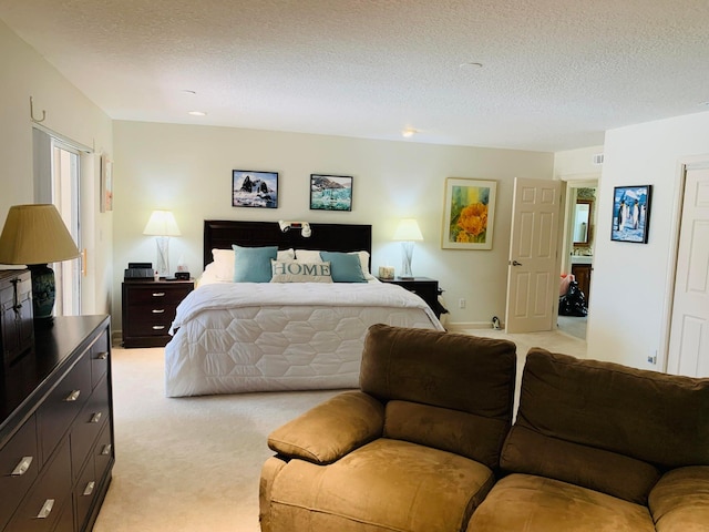 bedroom featuring light carpet and a textured ceiling