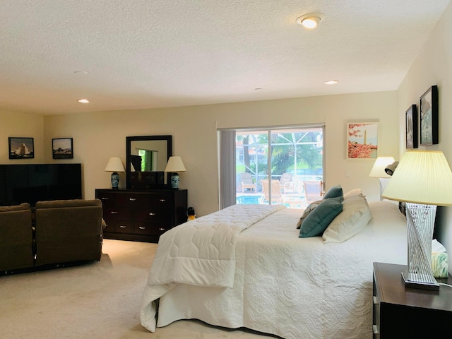 carpeted bedroom featuring access to outside and a textured ceiling