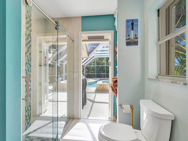 bathroom featuring walk in shower and toilet