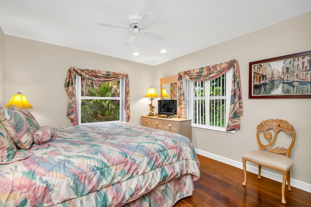 bedroom with ceiling fan and dark hardwood / wood-style flooring