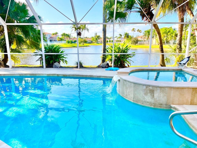 view of pool with an in ground hot tub, a water view, glass enclosure, and pool water feature