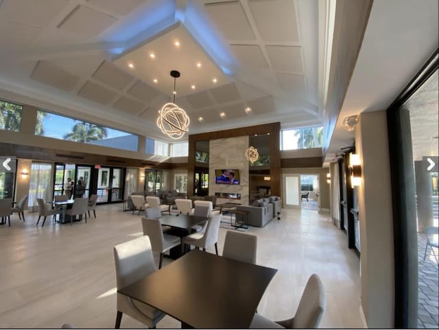 dining room featuring a towering ceiling and an inviting chandelier