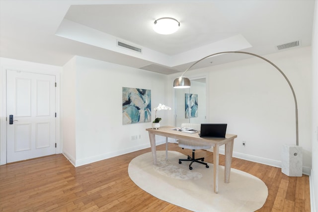 office featuring light wood-type flooring, baseboards, and visible vents