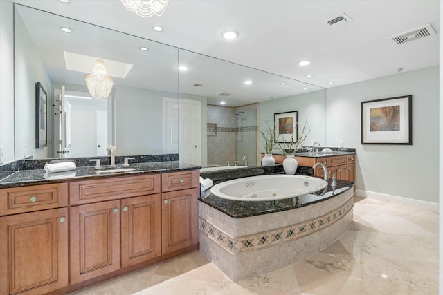 bathroom with a jetted tub, vanity, visible vents, and a shower stall