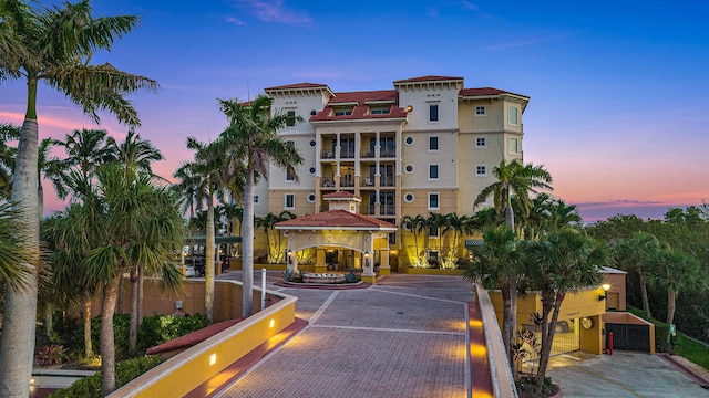 property at dusk with uncovered parking