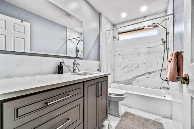 full bathroom with vanity, toilet, tile walls, and tiled shower / bath