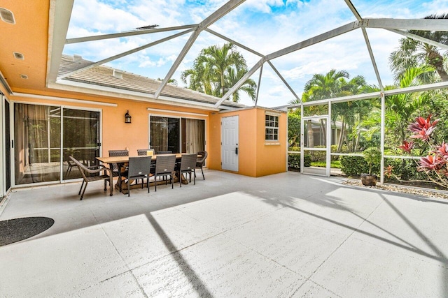 view of patio with glass enclosure