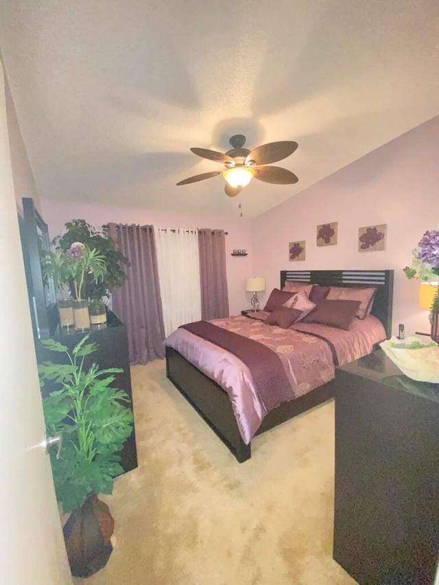 bedroom with lofted ceiling, carpet floors, and ceiling fan