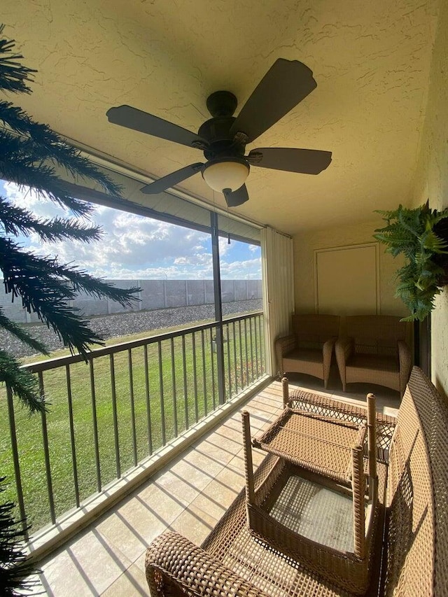 balcony with ceiling fan and an outdoor living space