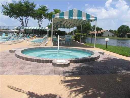 view of swimming pool featuring a patio and a community hot tub