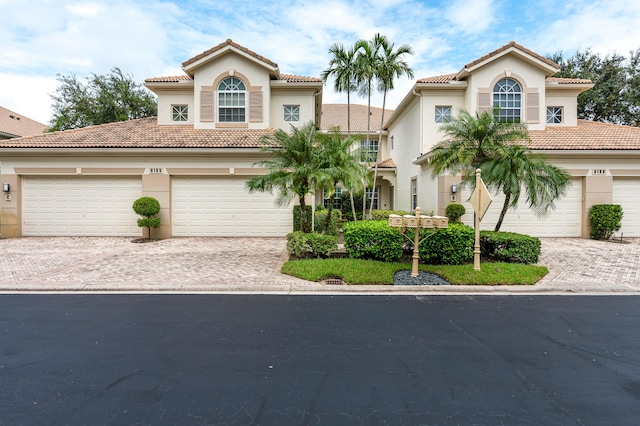 6189 Island Walk Unit A, Boca Raton, FL 33496 - mediterranean / spanish house featuring stucco siding, decorative driveway, and a tile roof