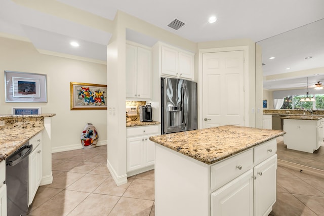 kitchen featuring light stone counters, a kitchen island, white cabinetry, stainless steel refrigerator with ice dispenser, and black dishwasher