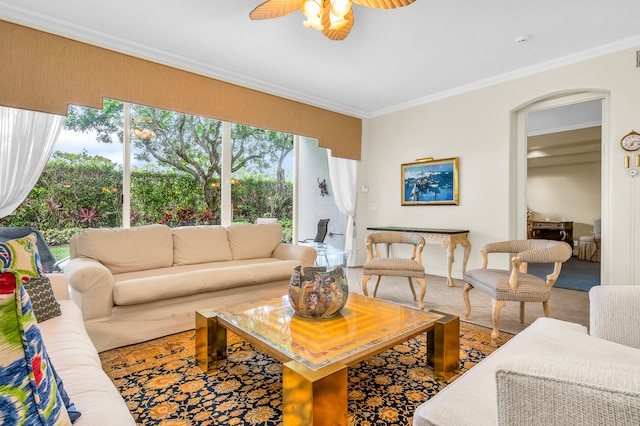 living room with crown molding and ceiling fan