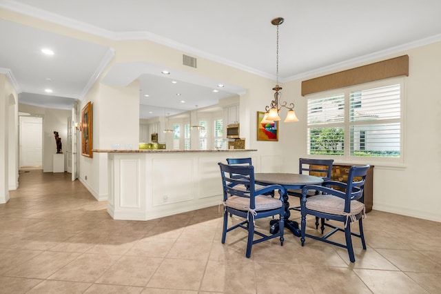 dining room with ornamental molding and light tile patterned floors