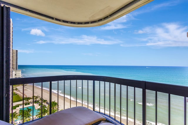 balcony with a water view and a beach view