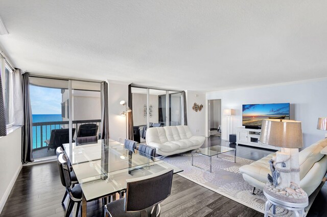 dining space featuring a water view, dark wood-type flooring, ornamental molding, and floor to ceiling windows