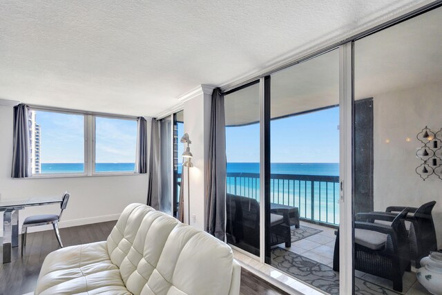 living room featuring a water view, a textured ceiling, and dark hardwood / wood-style flooring