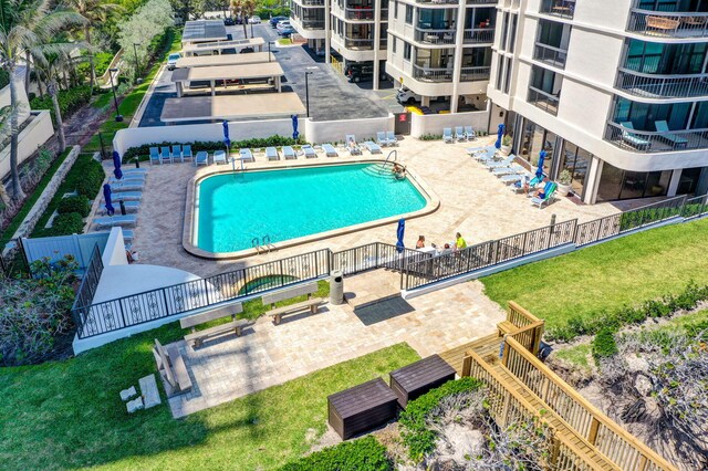 view of swimming pool with a patio and a lawn