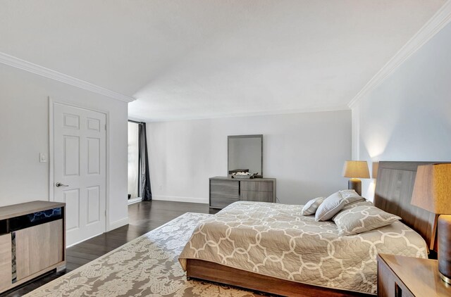 bedroom featuring crown molding and dark hardwood / wood-style flooring