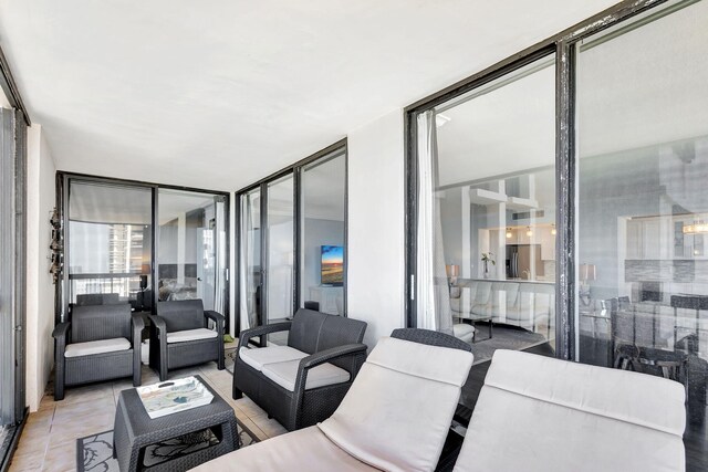 living room featuring expansive windows and light tile patterned floors