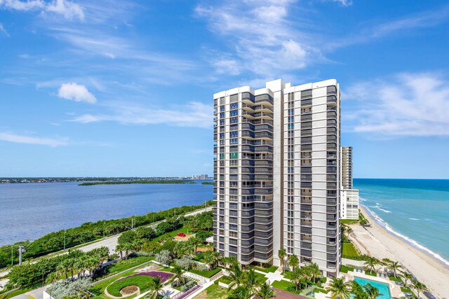 aerial view with a water view and a beach view