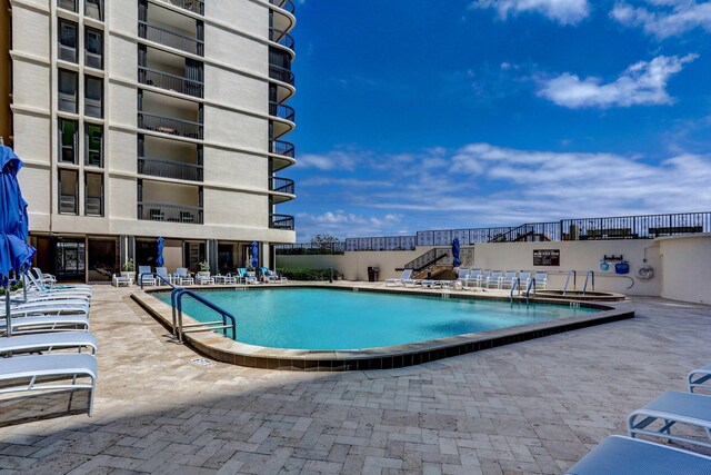 view of swimming pool with a patio