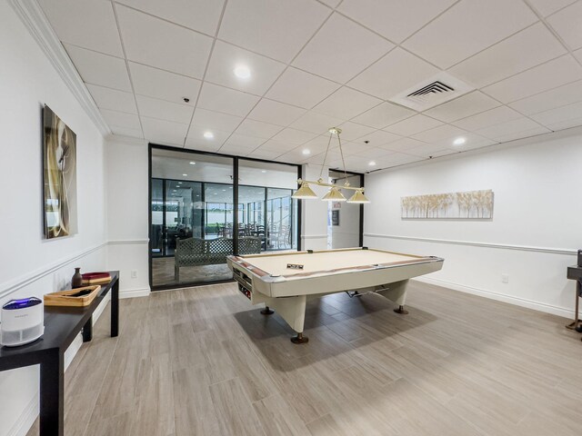 recreation room featuring crown molding, light wood-type flooring, billiards, a paneled ceiling, and floor to ceiling windows