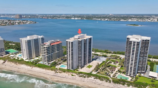 bird's eye view featuring a water view and a beach view