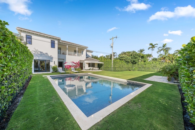 view of pool featuring a patio and a lawn