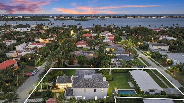 aerial view at dusk with a water view