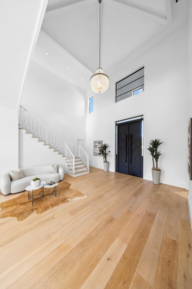 entrance foyer with wood-type flooring and an inviting chandelier